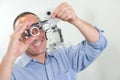 Optician holding eyetest glasses