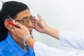 Optician male hands put glasses on elderly man testing his eye Royalty Free Stock Photo