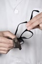 Optician man cleaning a pair of eyeglasses Royalty Free Stock Photo