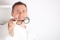 Optician offering glasses Royalty Free Stock Photo