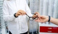 Optician, optometrist, oculist or eye doctor holding glasses and specs with new lenses Royalty Free Stock Photo