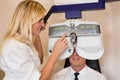 Optician or optometrist and patient with a phoropter