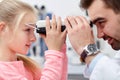 Optician with pupilometer and patient at eye clinic Royalty Free Stock Photo