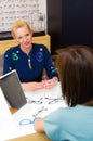 Optician salon saleswoman with her client choosing eyeglasses