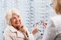 Optician selling glasses Royalty Free Stock Photo