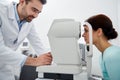 Optician with tonometer and patient at eye clinic Royalty Free Stock Photo