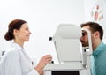 Optician with tonometer and patient at eye clinic Royalty Free Stock Photo
