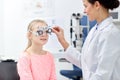 Optician with trial frame and girl at clinic Royalty Free Stock Photo