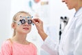 Optician with trial frame and girl at clinic Royalty Free Stock Photo