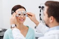 Optician with trial frame and patient at clinic
