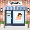 Opticians shop building with red bricks facade. Royalty Free Stock Photo