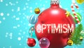 Optimism and Xmas holidays, pictured as abstract Christmas ornament ball with word Optimism to symbolize the connection and Royalty Free Stock Photo