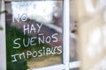 Optimist phrase written over old windows glasses in spanish