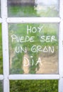 Optimist phrase written over old windows glasses in spanish Royalty Free Stock Photo