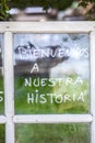 Optimist phrase written over old windows glasses in spanish Royalty Free Stock Photo