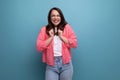 optimist young lady in shirt and jeans on studio isolated background