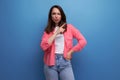 optimist young lady in shirt and jeans on studio isolated background