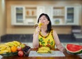 A mature woman enjoys life while eating bananas