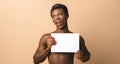 Smiling black young male model with blank poster Royalty Free Stock Photo