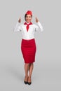 Optimistic air hostess gesturing forward Royalty Free Stock Photo
