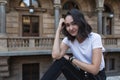 Optimistic asian girl in a white t-shirt, street portrat