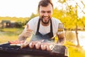 Happy man approving barbecue in countryside Royalty Free Stock Photo