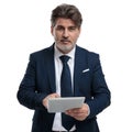 Optimistic businessman using his tablet and looking forward Royalty Free Stock Photo