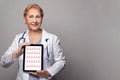 Optimistic doctor using digital tablet with heartbeat concept