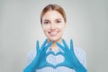 Optimistic doctor woman making heart and smiling. Healthcare, medicine and treatment concept