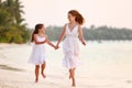 Happy family mother and daughter running in beach Royalty Free Stock Photo