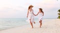 Happy family mother and daughter running in beach Royalty Free Stock Photo