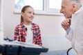 Optimistic girl enjoying visit to the physician in the hospital