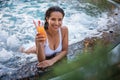 Optimistic girl tasting liquid in swimming pool Royalty Free Stock Photo