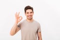 Optimistic man having bristle and brown hair showing ok sign on Royalty Free Stock Photo