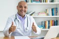 Optimistic medical scientist or doctor with bald working at computer