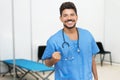Optimistic mexican male doctor is ready for vacinating patients