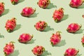 .Optimistic pattern made of superfood tasty dragon fruit. Pastel green background Royalty Free Stock Photo