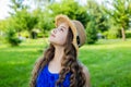 Optimistic smiling girl enjoying sunny summer day in park, carefree mood