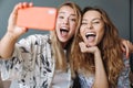 Optimistic women at home using mobile phone take a selfie Royalty Free Stock Photo