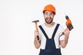 Optimistic young man holding drill and hammer Royalty Free Stock Photo