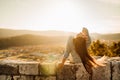 Optimistic young woman listening to music podcast stream over headphones,enjoying in nature at sunset.Day in nature.Stress Royalty Free Stock Photo