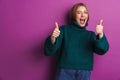 Optimistic young woman showing thumbs up