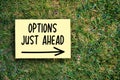 Options just ahead motivational message on paper on grass background. Inspirational quote to create future in business or life Royalty Free Stock Photo