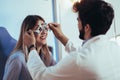 Optometrist checking patient eyesight and vision correction Royalty Free Stock Photo