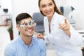 Optometrist checking patients vision with trial frame Royalty Free Stock Photo