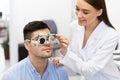 Optometrist checking patients vision with trial frame Royalty Free Stock Photo