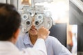 Optometrist doing sight testing for child patient in clinic, Indian child choosing eyeglasses in optics store, Boy doing eye test Royalty Free Stock Photo