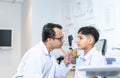 Optometrist doing sight testing for child patient in clinic, Indian child choosing eyeglasses in optics store, Boy doing eye test Royalty Free Stock Photo