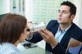 Optometrist in exam room with woman in chair