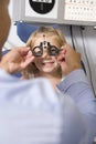 Optometrist in exam room with young girl Royalty Free Stock Photo